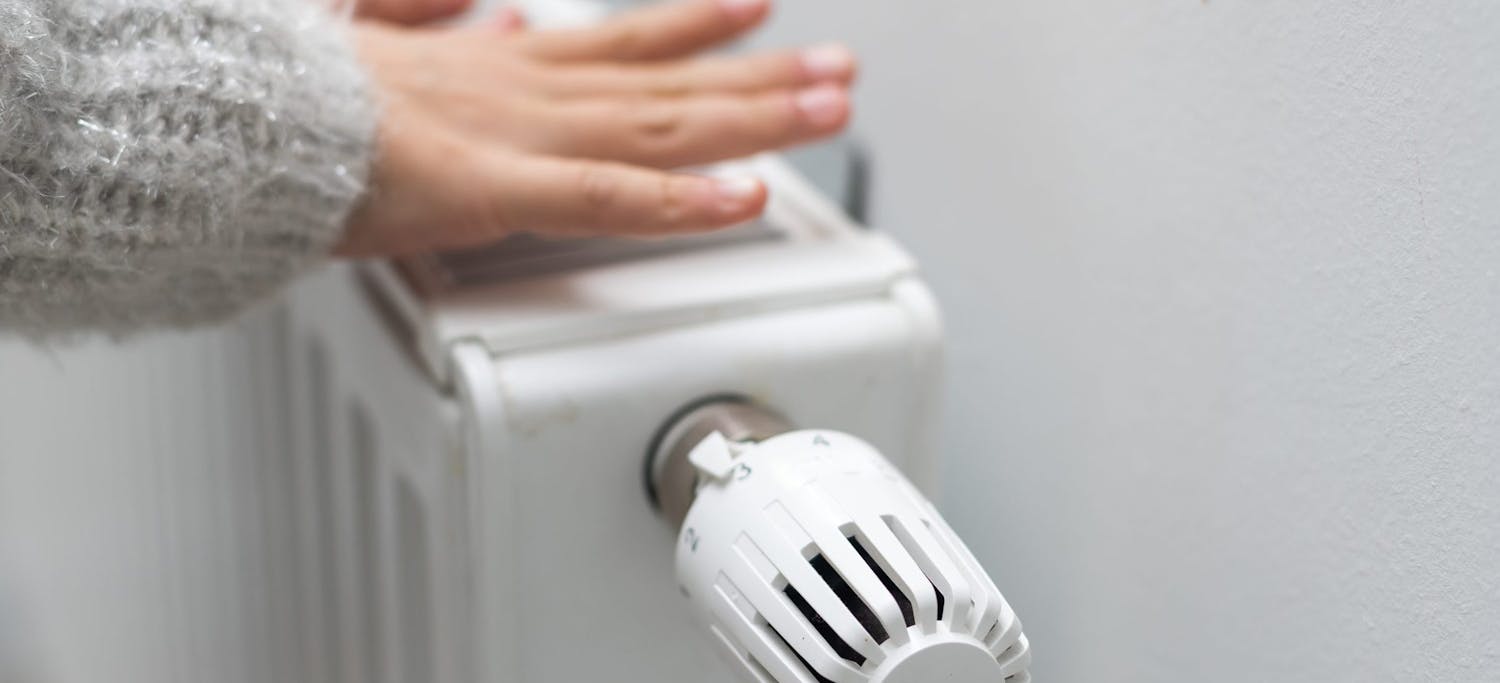 The,Child's,Hands,Warm,Their,Hands,Near,The,Heating,Radiator.